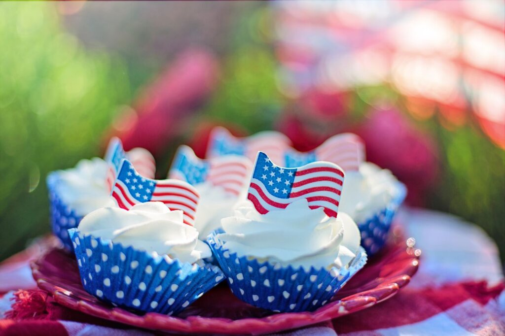 Patriotic cupcakes with American flags, perfect for Fourth of July celebrations.
